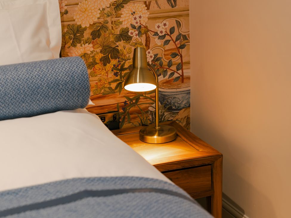 A bedroom with a bed, lamp, and nightstand at 33 Lorne Street in Chester