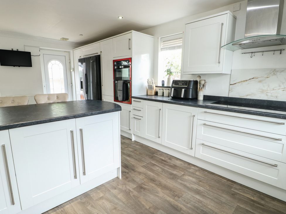A kitchen with cabinets and appliances at 9 Beckett Close Colwyn Bay