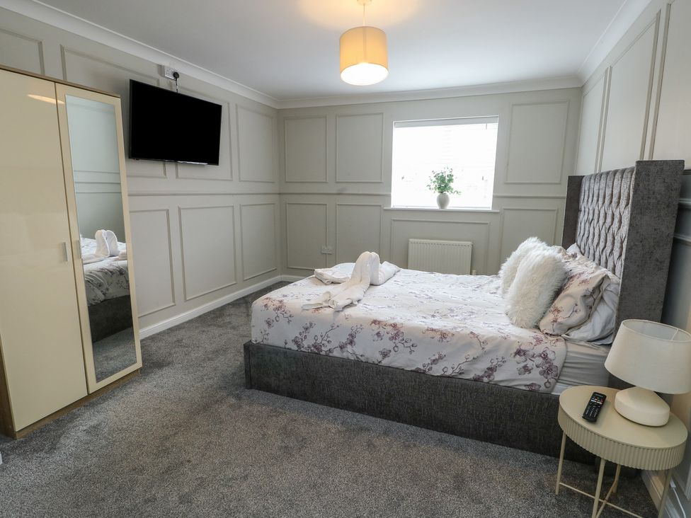 A bedroom with a bed and TV at 9 Beckett Close in Colwyn Bay