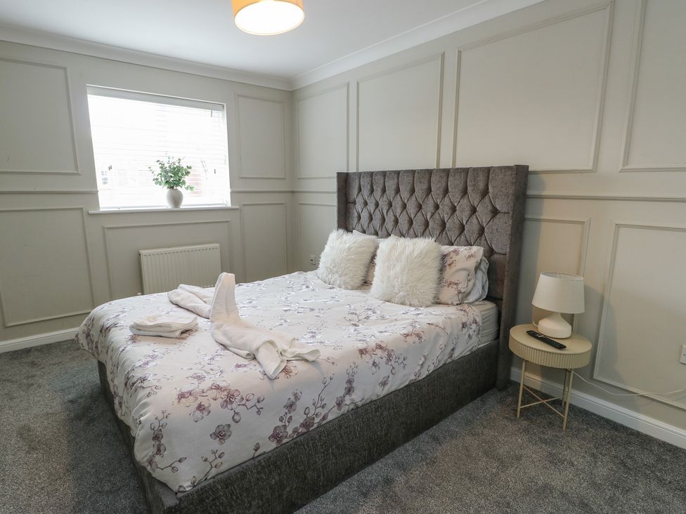 A bedroom with a bed and bedside table at 9 Beckett Close in Colwyn Bay