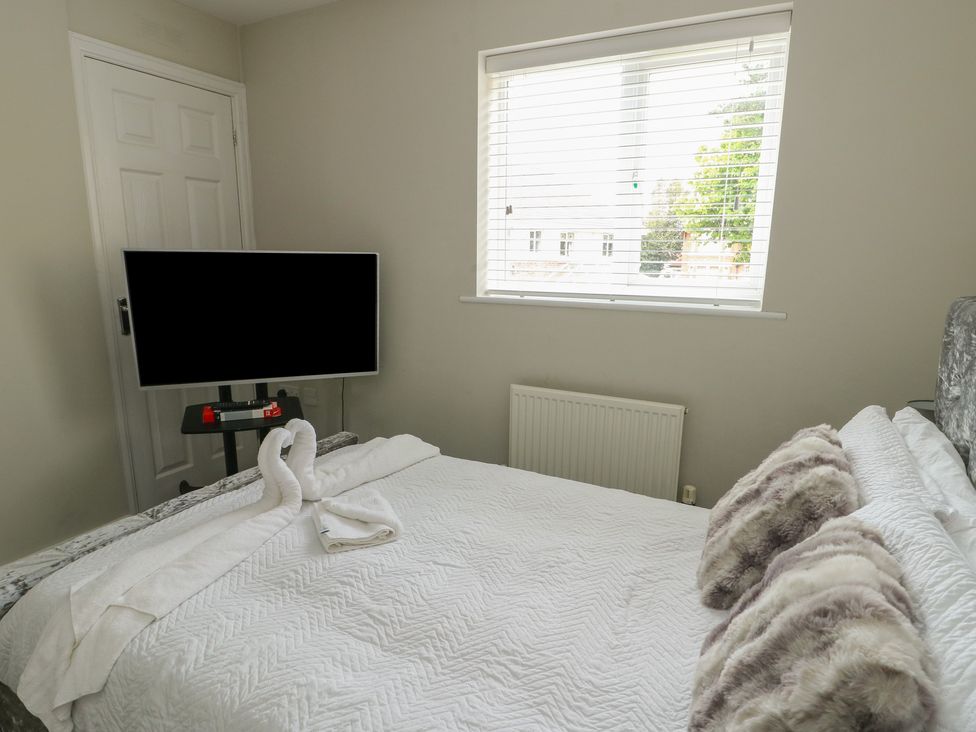A bedroom with a bed and television at 9 Beckett Close Colwyn Bay