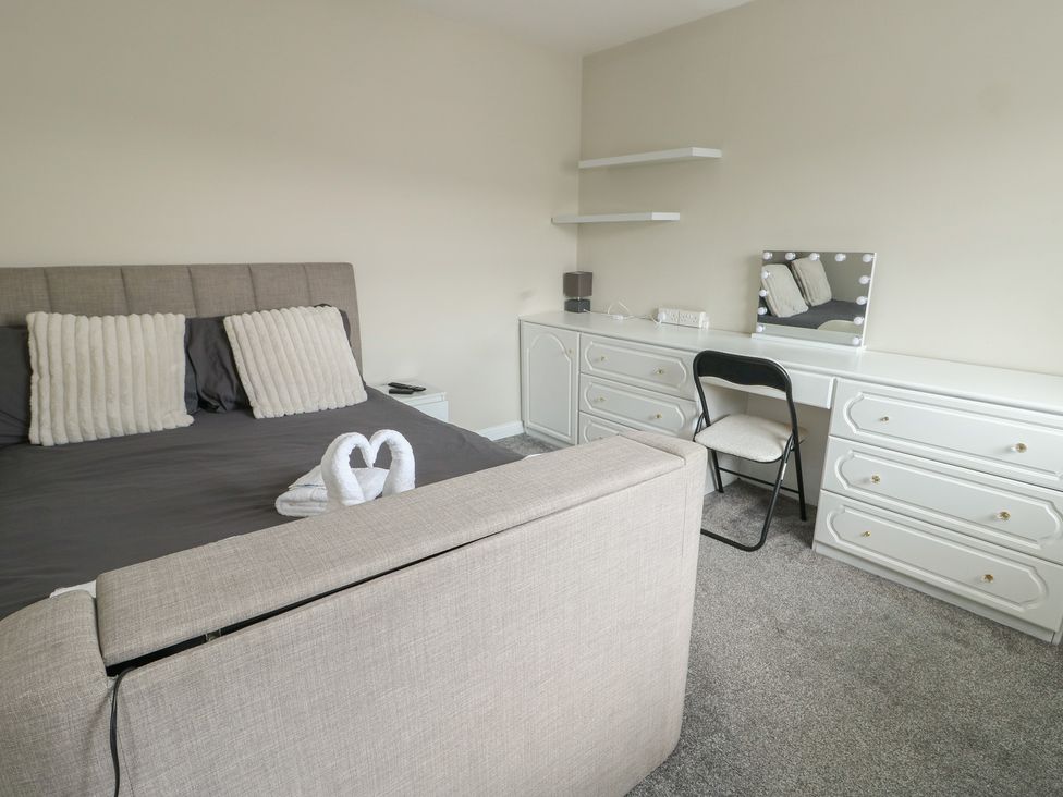 A bedroom with a bed and dresser at 9 Beckett Close Colwyn Bay