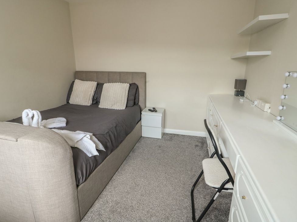 A bedroom with a bed and a desk at 9 Beckett Close Colwyn Bay