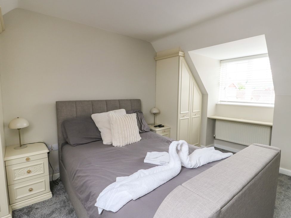A bedroom with a bed and window at 9 Beckett Close, Colwyn Bay