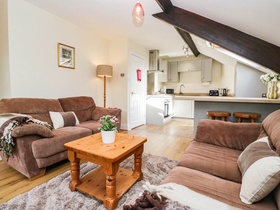 A living room with sofas and a coffee table at 2 Bakers Yard