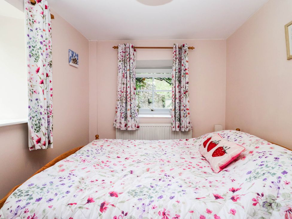 A bedroom with a bed and window at 2 Bakers Yard