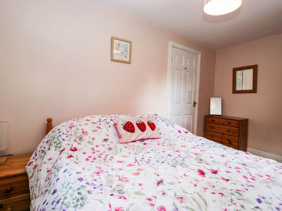 A bedroom with a bed and dresser at 2 Bakers Yard