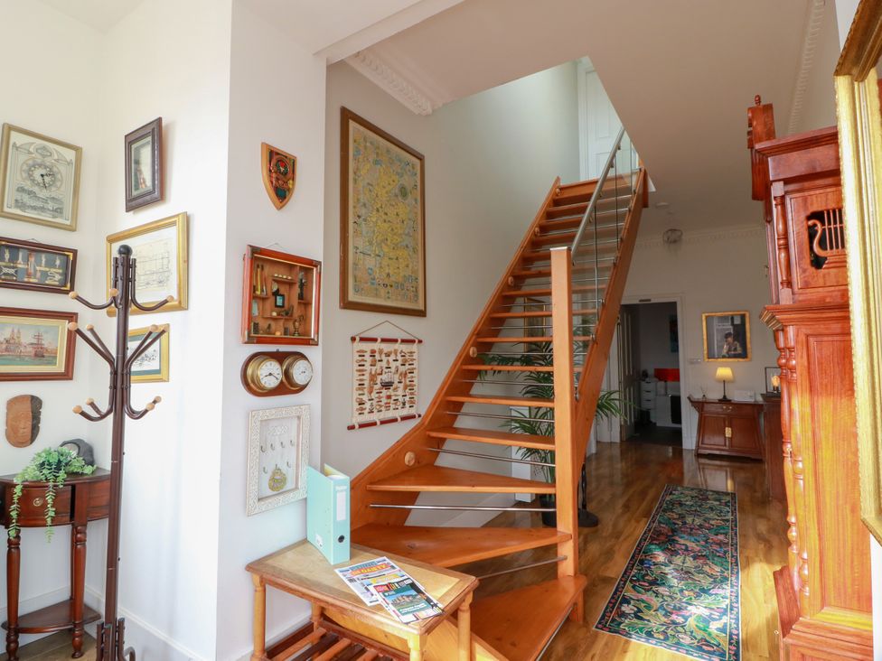 An entryway with a staircase and art on the walls at Ailsa View in Girvan