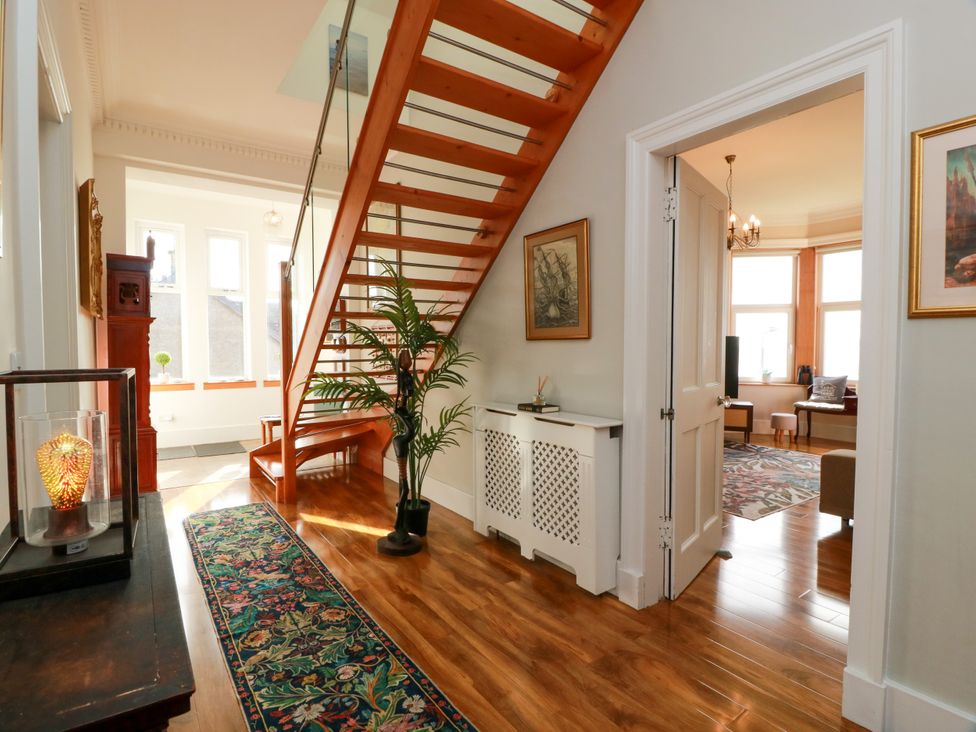 A hallway with a staircase and artwork at Ailsa View in Girvan