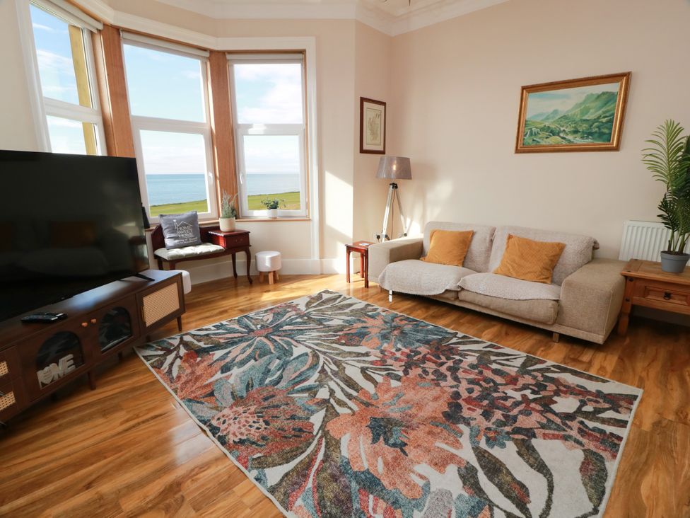 A living room with a sofa and television at Ailsa View in Girvan