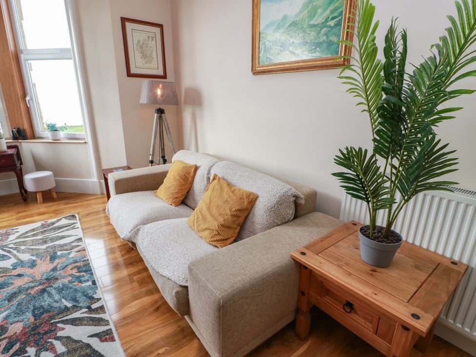 A living room with a sofa and a plant at Ailsa View in Girvan
