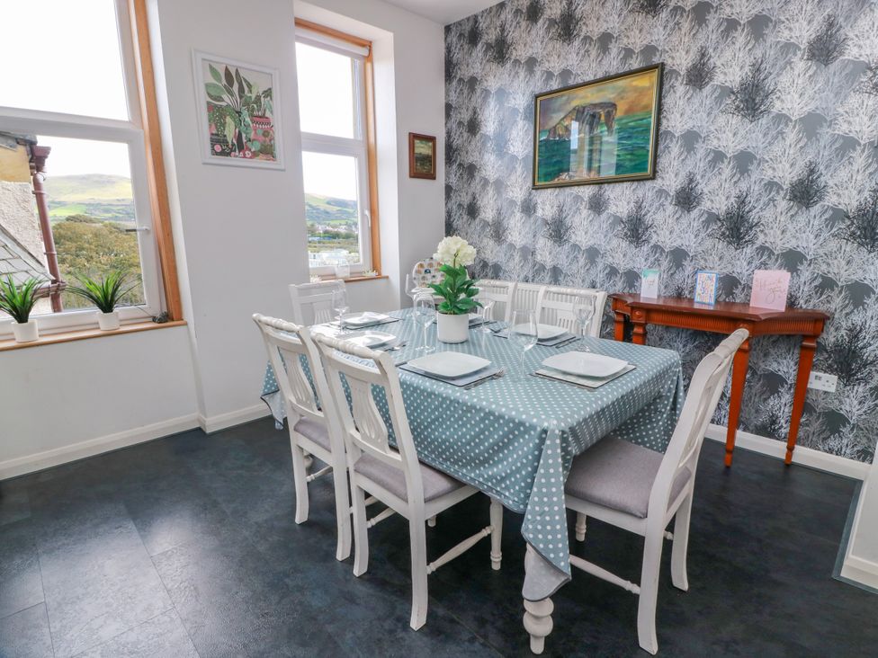A dining room with a table and chairs at Ailsa View in Girvan