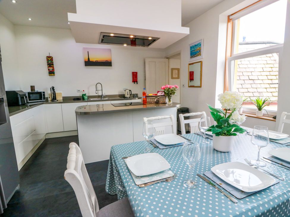 A kitchen with a dining table and chairs at Ailsa View in Girvan
