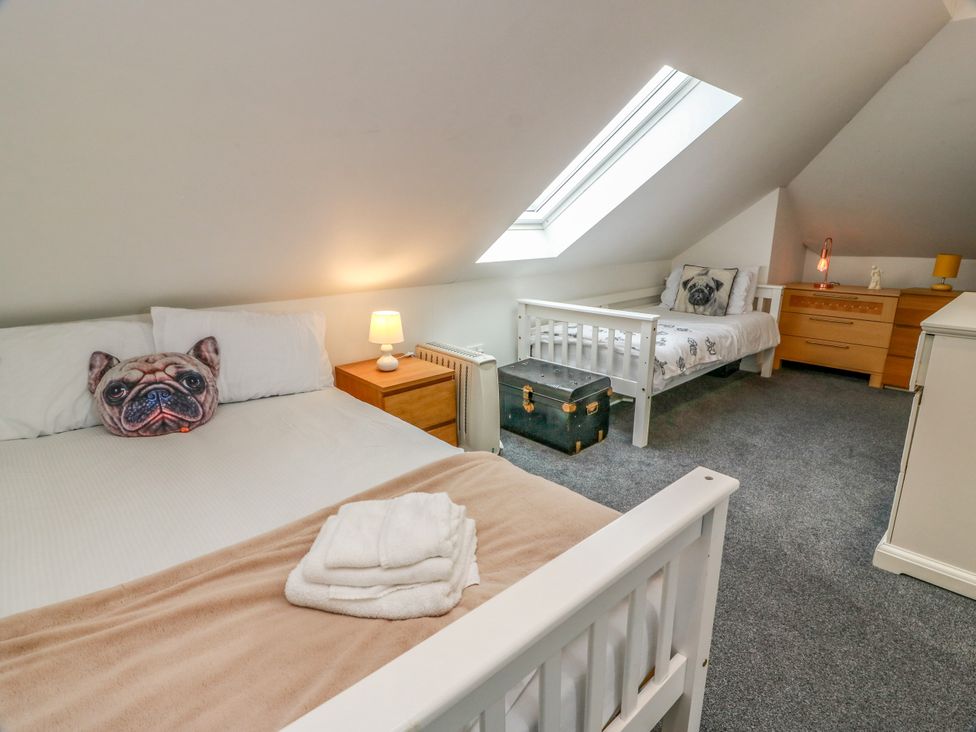 A bedroom with two beds and a skylight at Ailsa View in Girvan