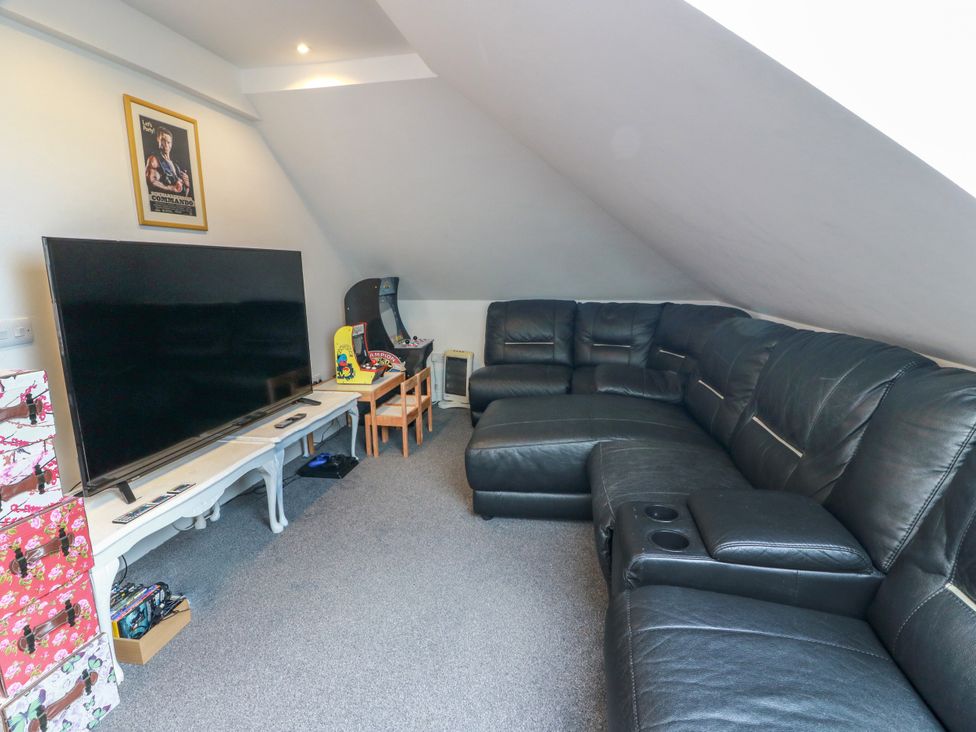 A living room with a television and a sofa at Ailsa View in Girvan