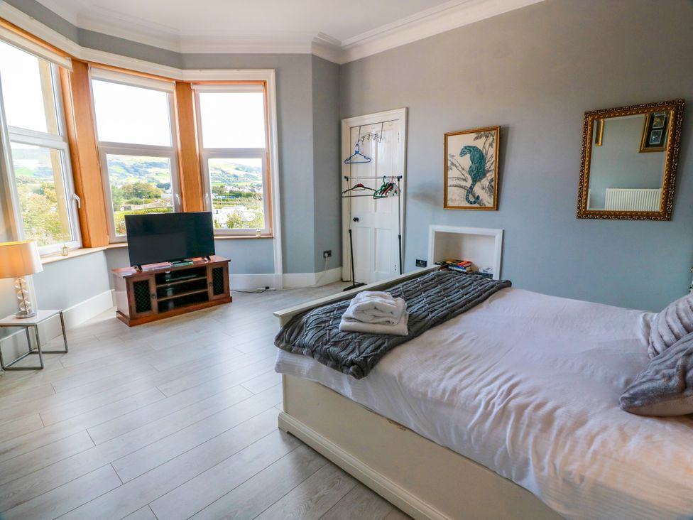 A bedroom with a bed and television at Ailsa View in Girvan