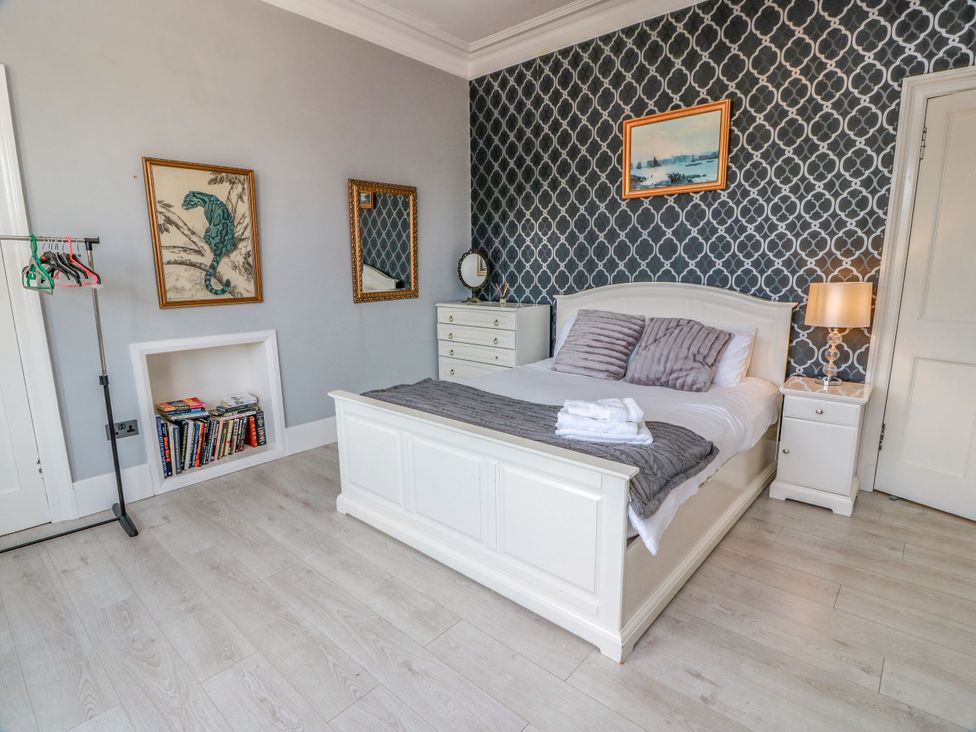 A bedroom with a bed and dresser at Ailsa View in Girvan