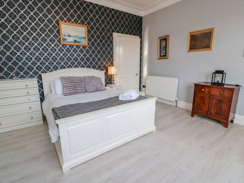 A bedroom with a bed and dresser at Ailsa View in Girvan