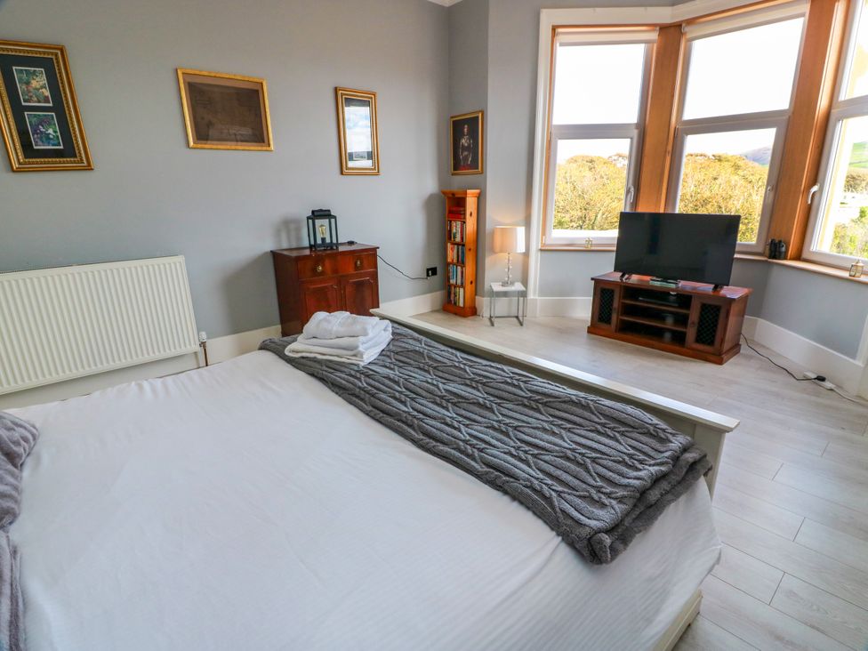 A bedroom with a bed and television at Ailsa View in Girvan