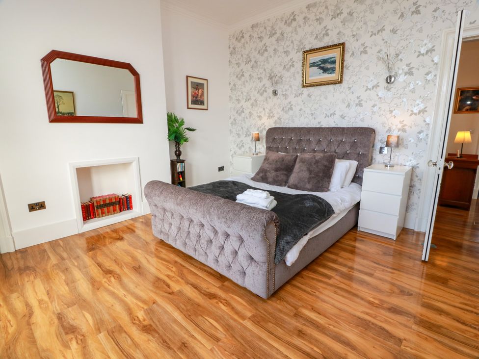 A bedroom with a bed and nightstands at Ailsa View in Girvan