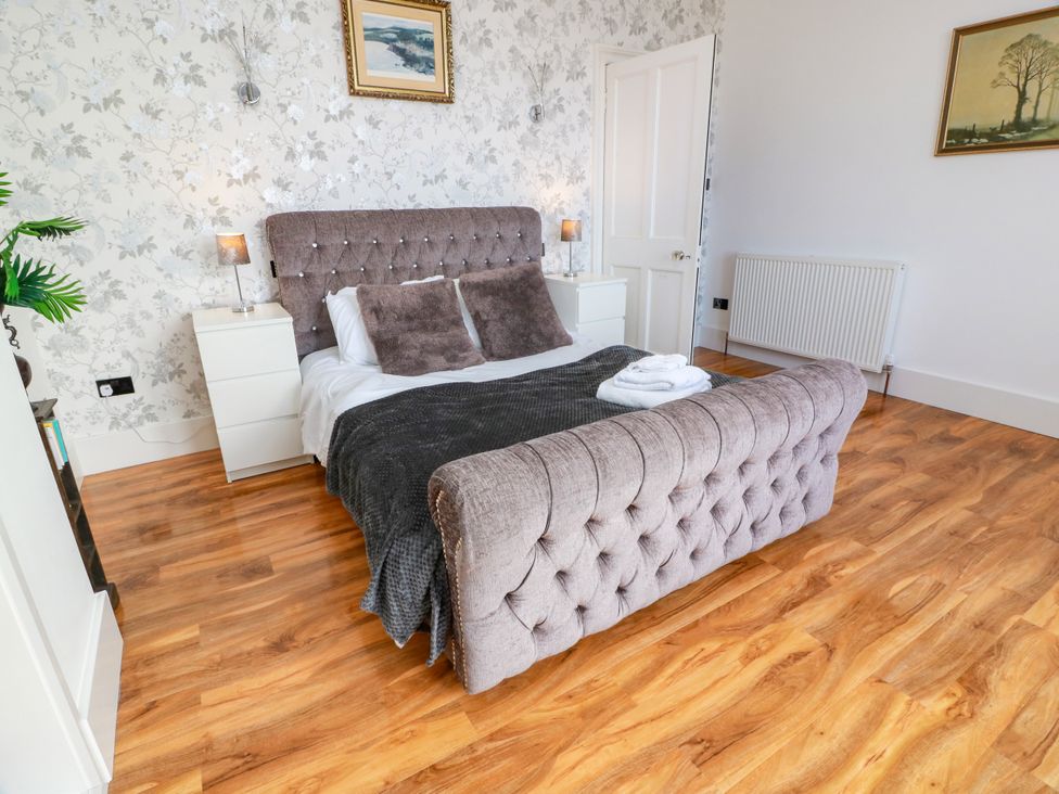 A bedroom with a bed and bedside table at Ailsa View in Girvan