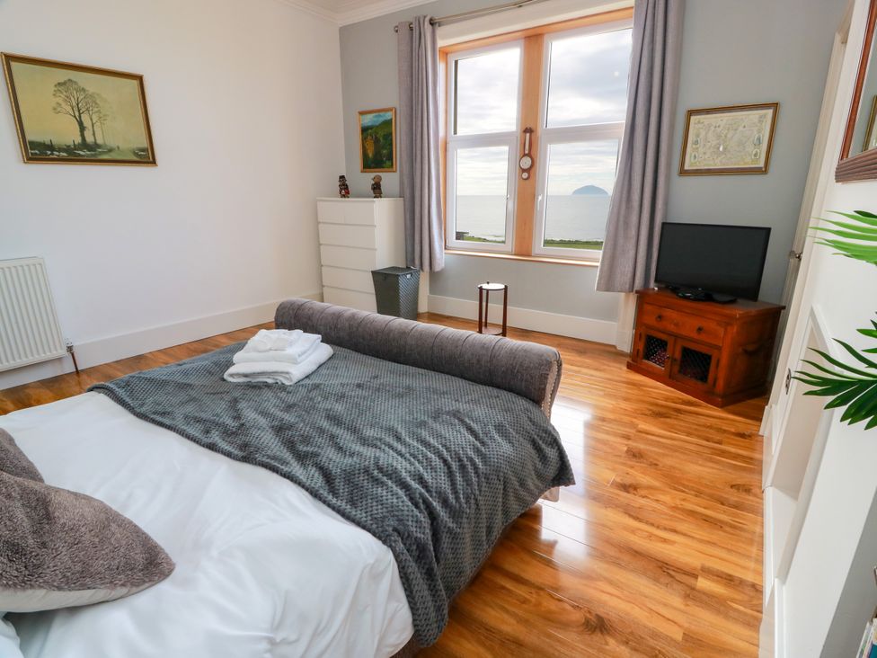 A bedroom with a bed and television at Ailsa View in Girvan