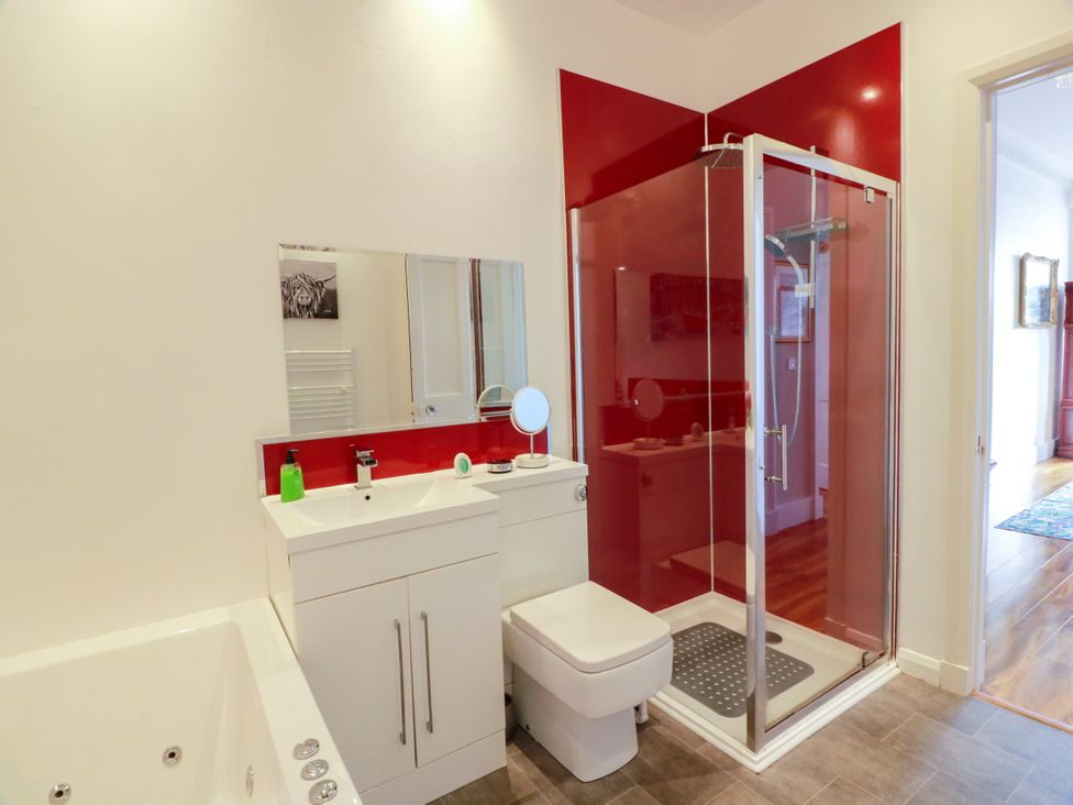 A bathroom with a bath tub and shower at Ailsa View in Girvan