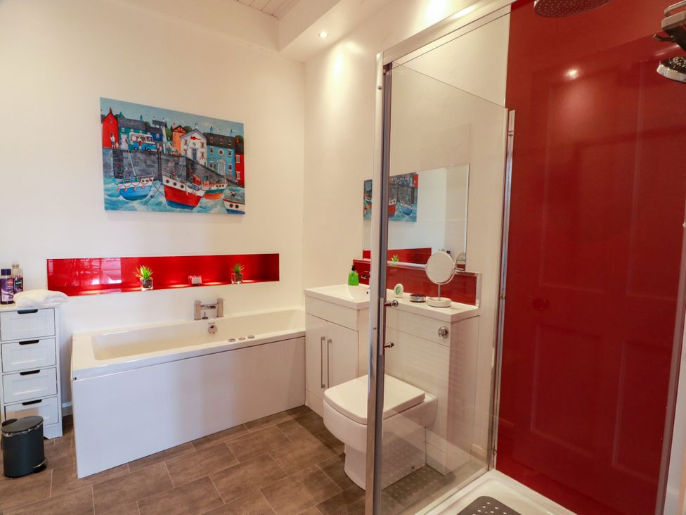 A bathroom with a bathtub and shower in Ailsa View Girvan
