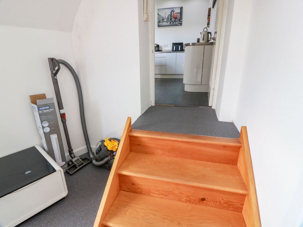 A hallway with steps leading to a kitchen at Ailsa View Girvan