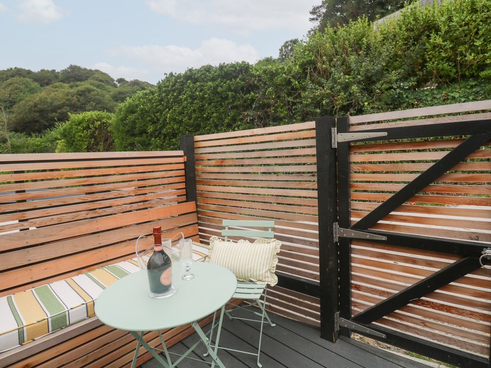 An outdoor patio with a table and chairs at Mavericks Wave in St Agnes