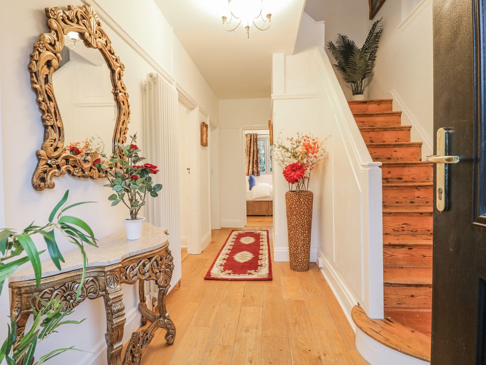 A hallway with a mirror and console table at Mellbreak in Ashby-De-La-Zouch