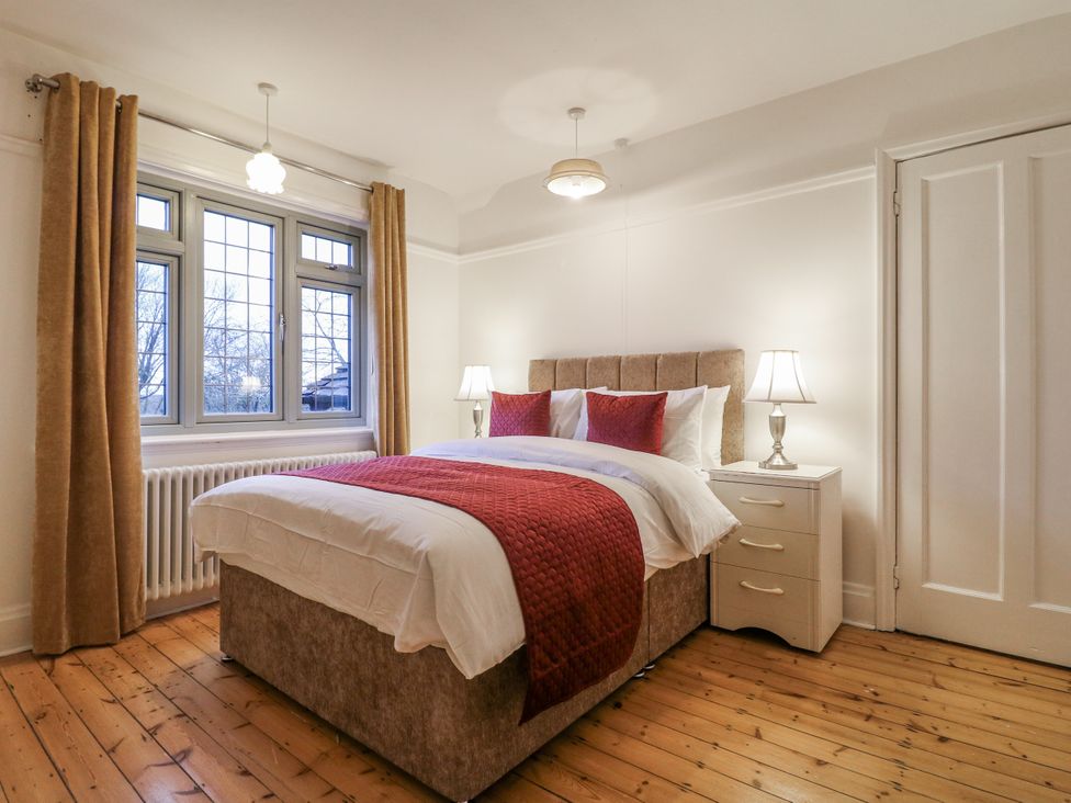 A bedroom with a bed and nightstand at Mellbreak Ashby-De-La-Zouch