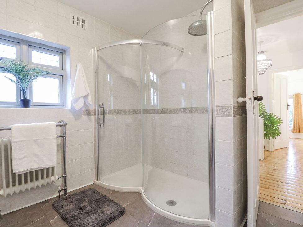 A bathroom with a shower and towel rack at Mellbreak in Ashby-De-La-Zouch