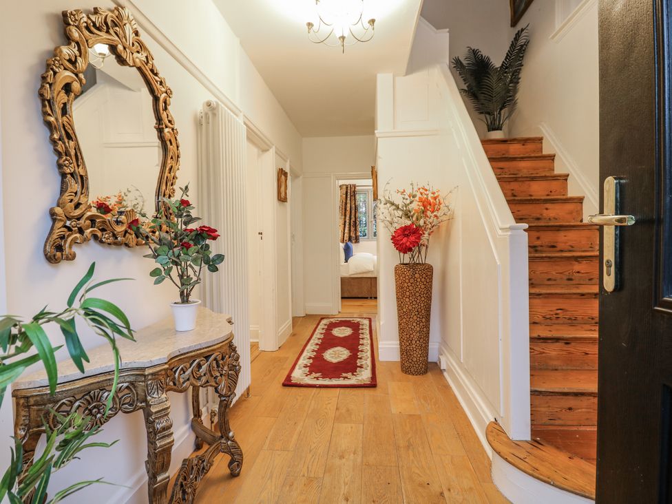 A hallway with a mirror and console table at Mellbreak in Ashby-De-La-Zouch