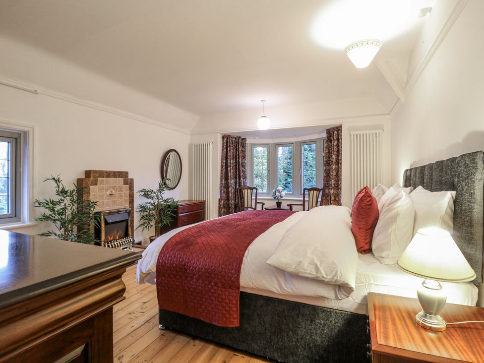 A bedroom with a bed and a fireplace at Mellbreak in Ashby-De-La-Zouch