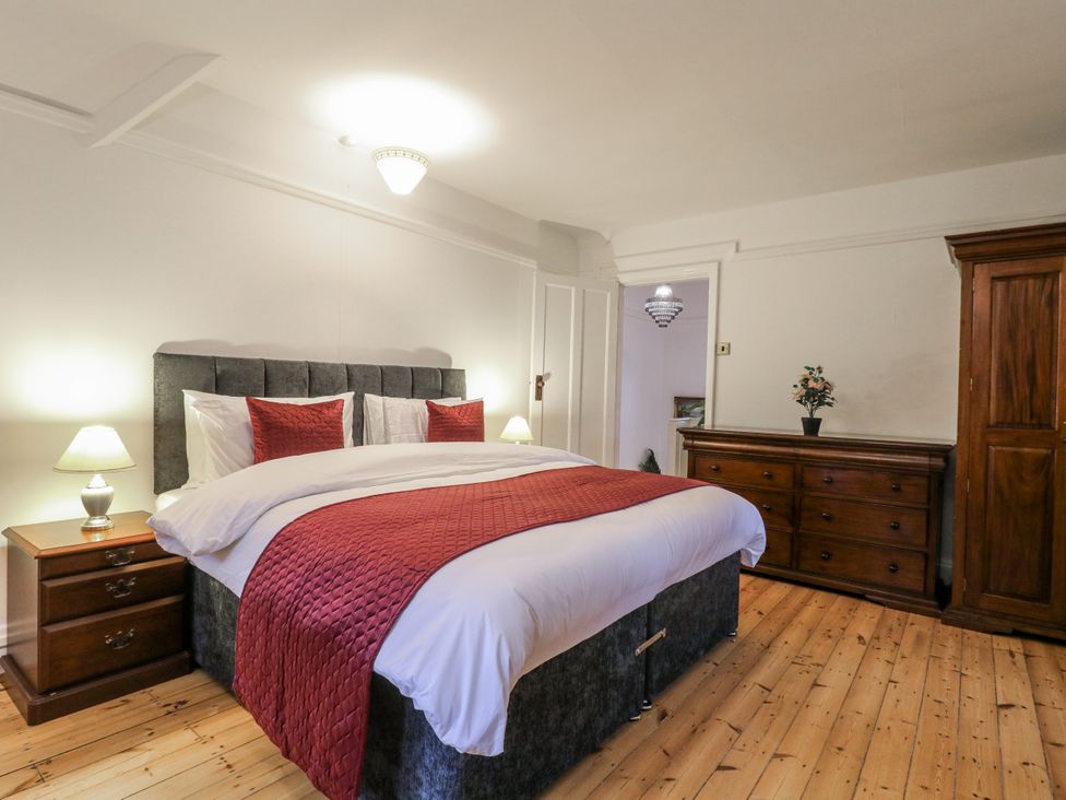 A bedroom with a bed and dresser at Mellbreak Ashby-De-La-Zouch