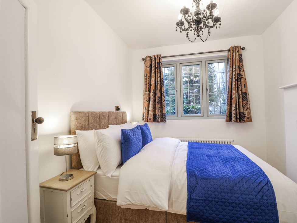 A bedroom with a bed and curtains at Mellbreak in Ashby-De-La-Zouch