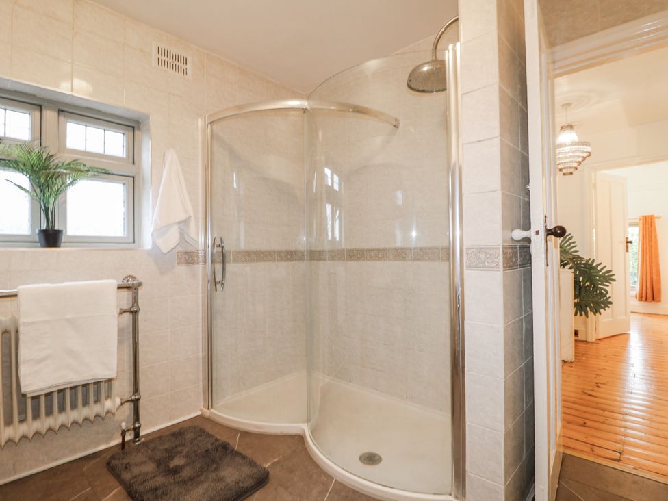 A bathroom with a shower and radiator at Mellbreak in Ashby-De-La-Zouch