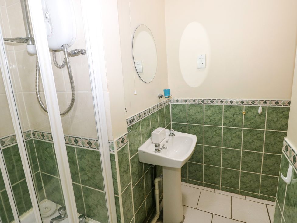 A bathroom with a shower and sink at The Bungalow in Porthcawl