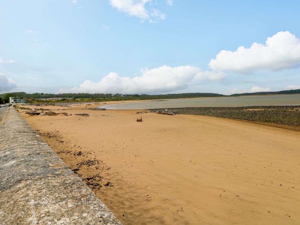A beach with sand and water at The Bungalow in Porthcawl