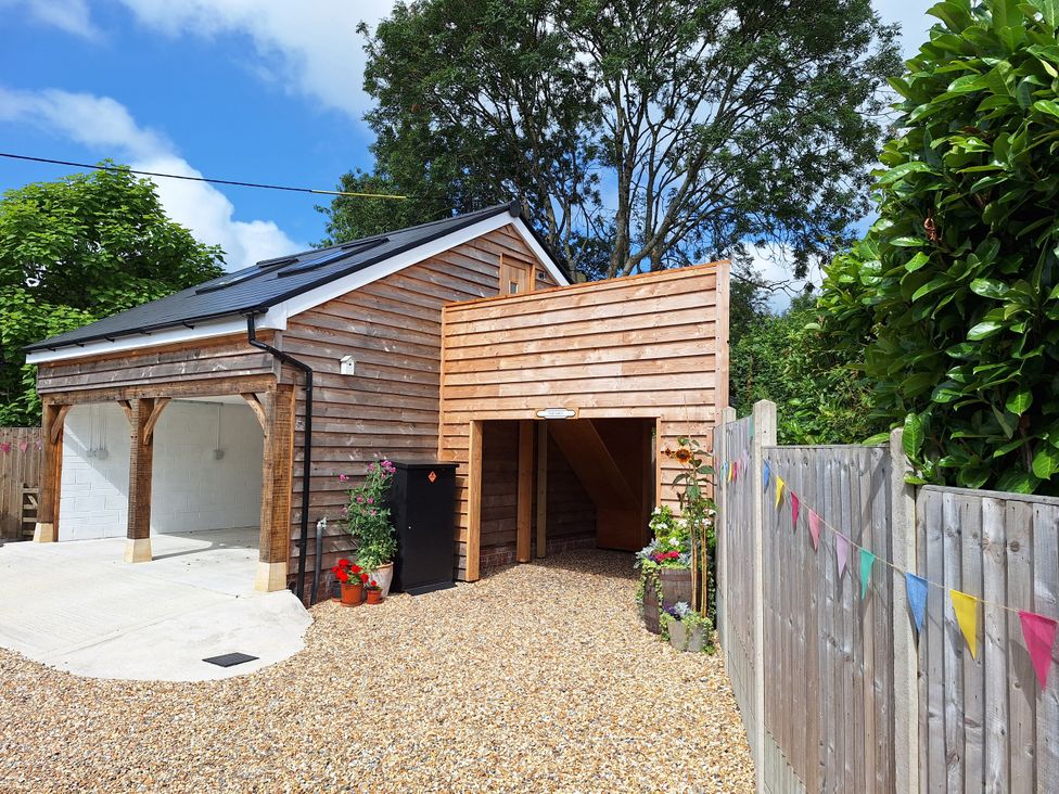 A garage with a driveway and gravel at The Halt in Maiden Newton