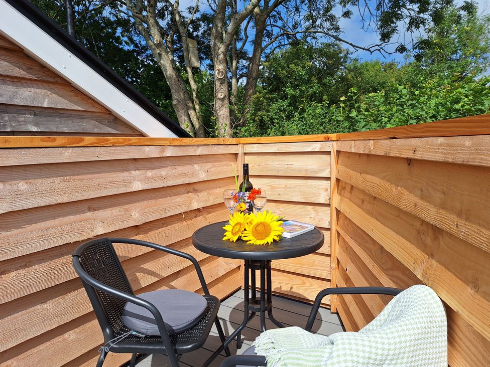 An outdoor seating area with a table and two chairs at The Halt in Maiden Newton