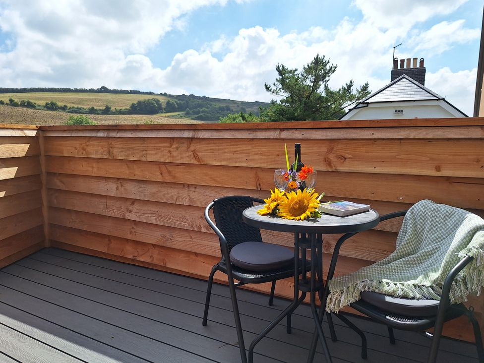 An outdoor terrace with a table and chairs at The Halt in Maiden Newton