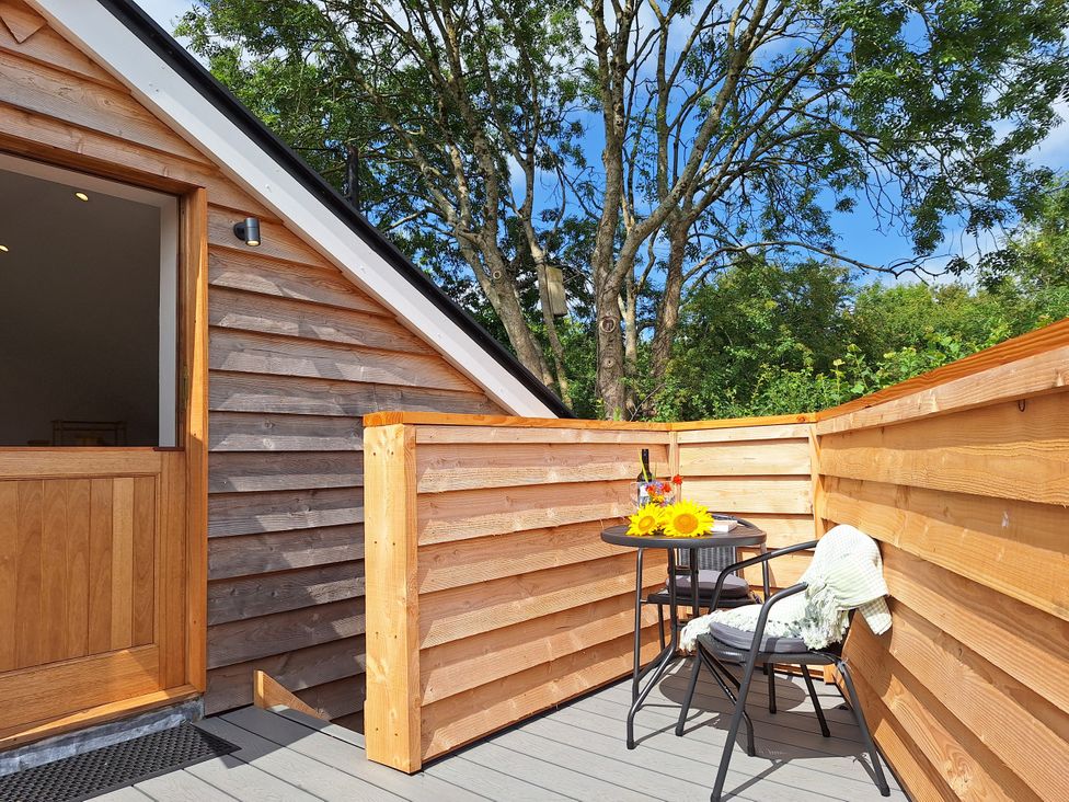 A balcony with a table and chairs at The Halt in Maiden Newton