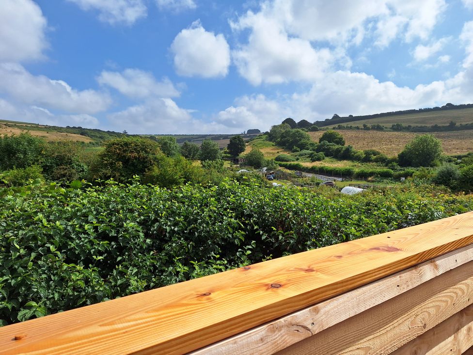 A landscape view with greenery and hills at The Halt in Maiden Newton