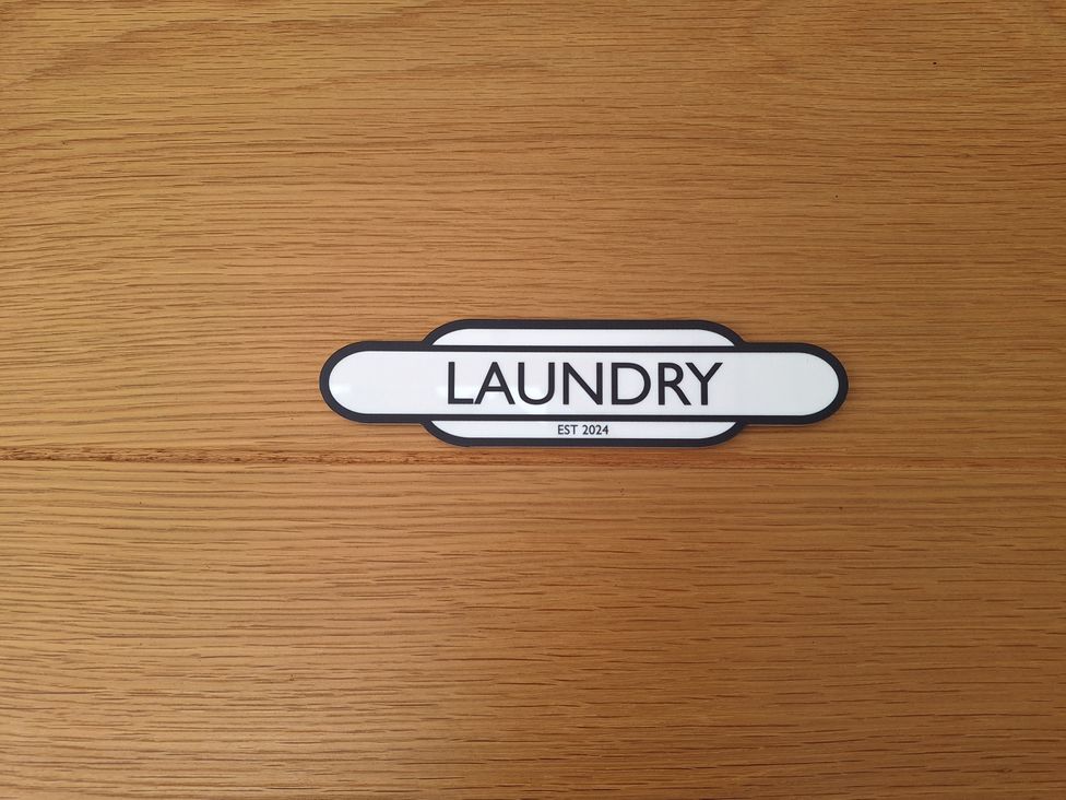 A laundry sign on wooden surface at The Halt in Maiden Newton