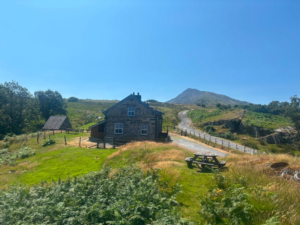 A house with a mountain in the background at Ty Llugwy Capel Curig near Betws-Y-Coed