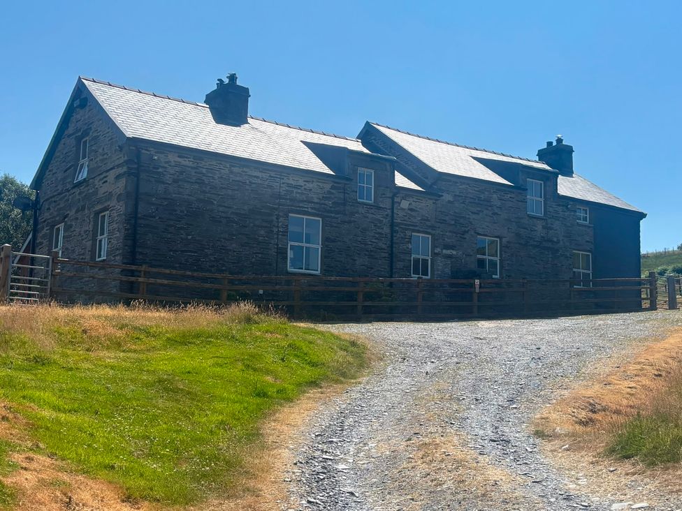 A house with windows and a path at Ty Llewelyn Capel Curig near Betws-Y-Coed