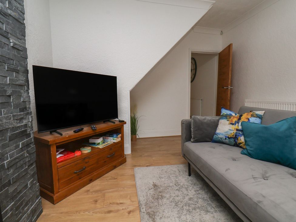 A living room with a television and sofa at 174 High Street, Marske-By-The-Sea