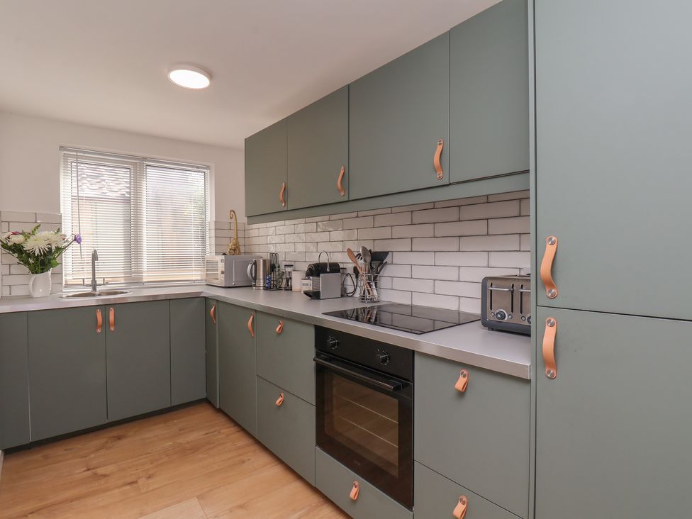 A kitchen with cabinets and appliances at 174 High Street, Marske-By-The-Sea